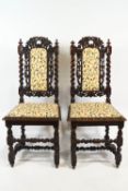 A pair of Victorian oak chairs the carved and pierced backs with barley twist columns and