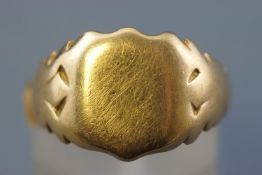 A yellow metal shield shaped signet ring. Hallmarked 18ct gold, Chester, 1909. Size: M