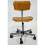 A 1970's office chair with bent plywood seat and back,