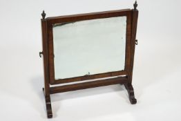 A George III oval framed dressing mirror, on base with a drawer and another,