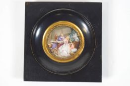 An 18th century French style round miniature of a couple in an interior, in a blackened frame,