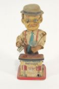 A battery operated tin plate and plastic figure of Charlie Weaver Bartender,