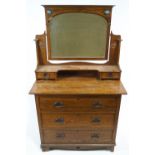 An Arts and Crafts style oak dressing table and mirror,