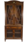 A Continental mahogany bookcase with two glazed doors above a frieze drawer and two grilled doors,