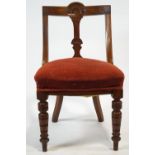 A Victorian mahogany chair with carved shaped back, stuff over seat on turned tapering legs,