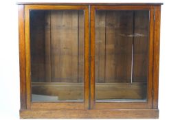 A 19th century mahogany two glazed door bookcase, of plain rectangular form,