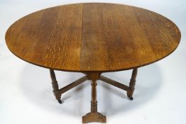 An oval oak gate leg table,