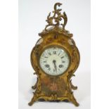 A Louis XVI style mantel clock, the brass mounted case painted with a lady in a garden,