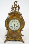 A Louis XVI style mantel clock, the brass mounted case painted with a lady in a garden,