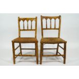 A pair of faux bamboo side chairs with scumbled finish and woven rush seats with bobbin turned back