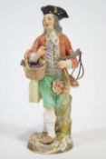 A porcelain Meissen style figure of a grape seller,