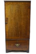 A 19th century mahogany cupboard of plain rectangular form with banded edge door and plain drawer