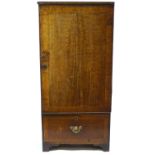 A 19th century mahogany cupboard of plain rectangular form with banded edge door and plain drawer