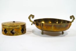 A spot hammer finish brass quatrefoil two handled bowl raised on three ball and claw feet,