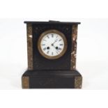 A Victorian slate and marble mantel clock, with white enamel dial enclosing an eight day movement,