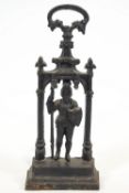 A cast iron door porter in the Gothic style, with a knight in armour holding a shield and halberd,