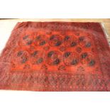 A Turkish Caucasian rug with two rows of five medallions on a red ground within multiple borders,