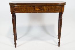 A George III mahogany card table, with inlaid frieze on turned tapering legs,