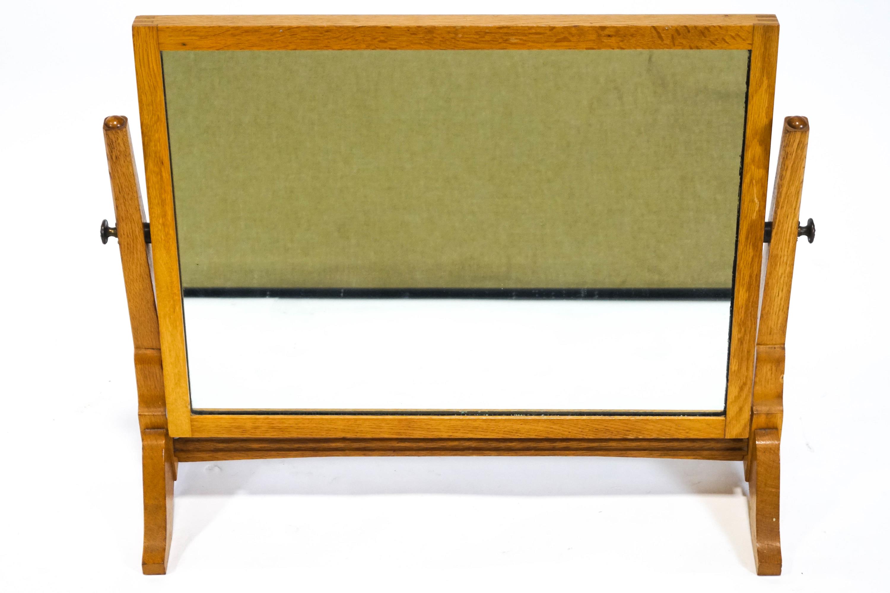 An Edwardian oak swing frame dressing table mirror,