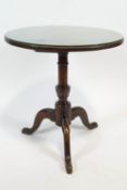 A George III oak tilt-top table, on turned pedestal and cabriole legs,