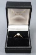 A yellow metal single stone ring. Set with a round brilliant cut diamond of approximately 0.46cts.