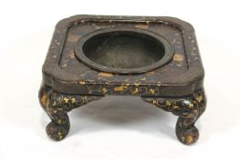A 19th century Japanese lacquer pot stand (or hibachi), decorated with gilt foliate scrolls,