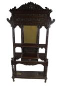 A Victorian carved oak hall stand,with central mirror to the back and a frieze drawer,