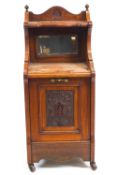 An Edwardian mahogany coal purdonium, with mirrored back,