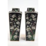 A pair of Chinese porcelain black ground lamp bases, of tapering square section,