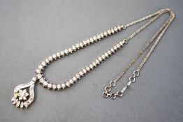 A white metal centrepiece necklace set.