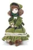A musical automaton doll, with bisque head and hands, seated on a music box,