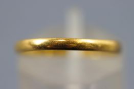 A yellow metal D shaped 2.2mm wedding ring. Hallmarked 22ct gold, Birmingham, 1946.