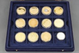 A boxed set of 24 proof gilt coins, The Legendary Aircraft Collection, and a case of others,