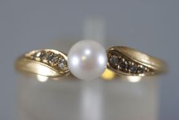 A yellow metal dress ring principally set with a 5mm cultured pearl