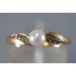 A yellow metal dress ring principally set with a 5mm cultured pearl