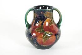 A Moorcroft 'Pomegranate' pattern two handled vase, circa 1900, printed painted and impressed marks,