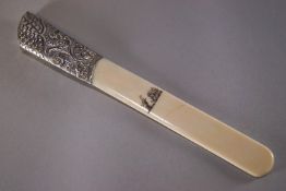 An ivory and silver mounted armorial paper flip, the silver cast with scale and acanthus pattern,