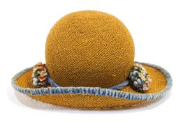 A Ridgmont child 's hat, trimmed with blue velvet and two flower sprigs,