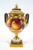 A Royal Worcester two handled vase and cover, painted in polychrome enamels with fruit by T Nutt,