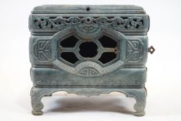 A pale blue enamel rectangular section stove, moulded with Chinese style scroll and fretwork,