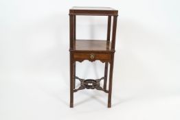 A 19th century mahogany two tier washstand with fluted uprights and one frieze drawer,