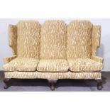 A large Victorian winged high back three seater sofa,