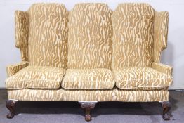 A large Victorian winged high back three seater sofa,