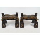 A pair of camel stools, each with leather seats,