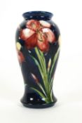 A Moorcroft 'Freesia' pattern inverted baluster vase on blue ground, early 20th century,