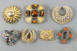 A collection of twenty costume brooches of variable designs.