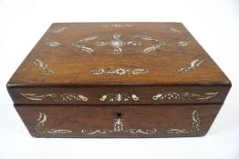 A rosewood work box of rectangular section, inlaid with mother of pearl leaves,