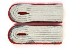 A pair of Third Reich epaulettes in red felt applied with four concentric rows of silvered cord,