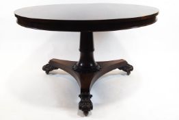 A rosewood pedestal breakfast table, the circular drum table top above a foliate column,