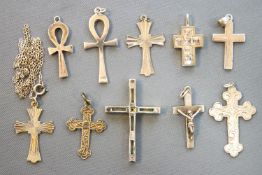 A collection of ten sterling silver cross pendants of variable designs, one has a chain.